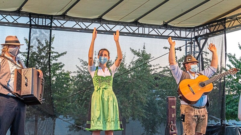 Anja Köckeis als "Klatschanimateurin", umrahmt von den beiden Wirtshausmusikern Tom und Basti.