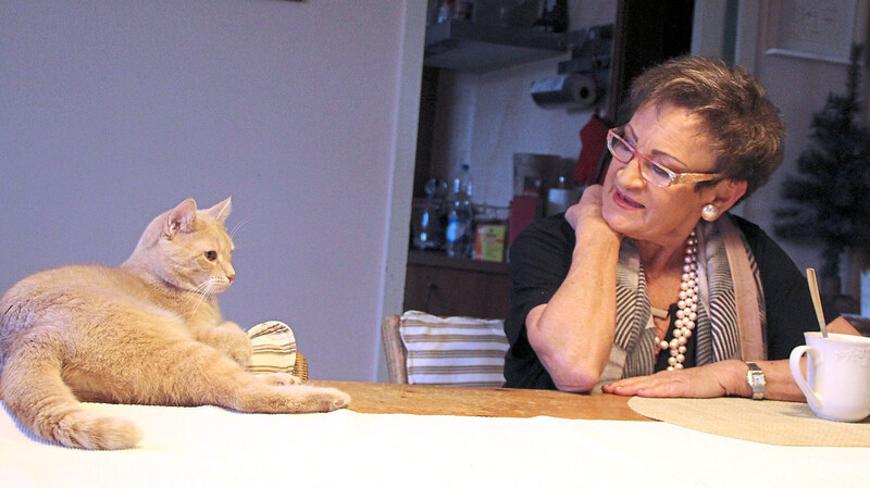 Macht es sich ab und an auch auf dem Tisch bequem: Kater Rudi, so fast auf Augenhöhe mit Hannelore Bergfeld.