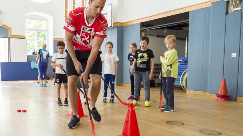 So geht's! Eisbären-Stürmer Peter Flache mit Grundschülern der Von-der-Tann-Schule in Regensburg.