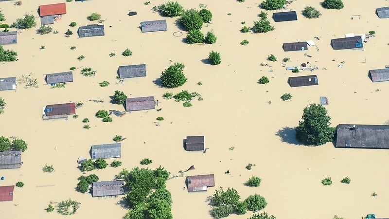 Juni 2013: Dächer ragen nahe Deggendorf nach einem Dammbruch aus dem Hochwasser.  Foto: Armin Weige l