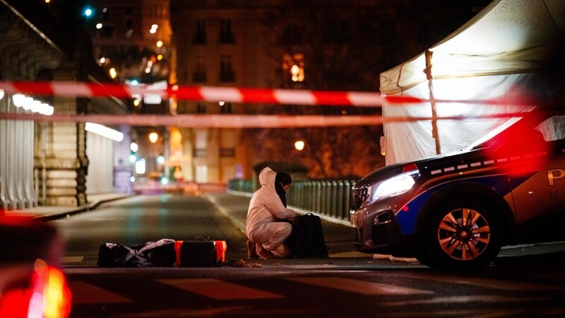 Ein Beamter der Kriminalpolizei arbeitet am Tatort. Ein mutmaßlicher Islamist hat unweit des Eiffelturms am Samstagabend einen deutschen Touristen mit einem Messer getötet.