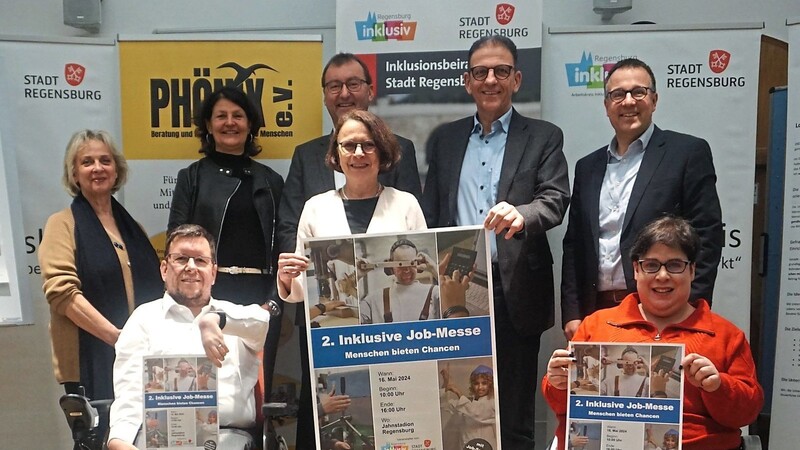 Frank Reinel (vorne links), Oberbürgermeisterin Gertrud Maltz-Schwarzfischer und weitere Organisatoren und Arbeitgeber präsentierten das druckfrische Plakat zur Messe.