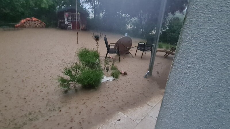 Schlammiges Wasser zerstörte Gärten.